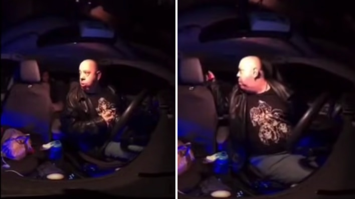 bald man sitting in a dark car