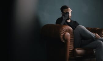 upset young man on couch